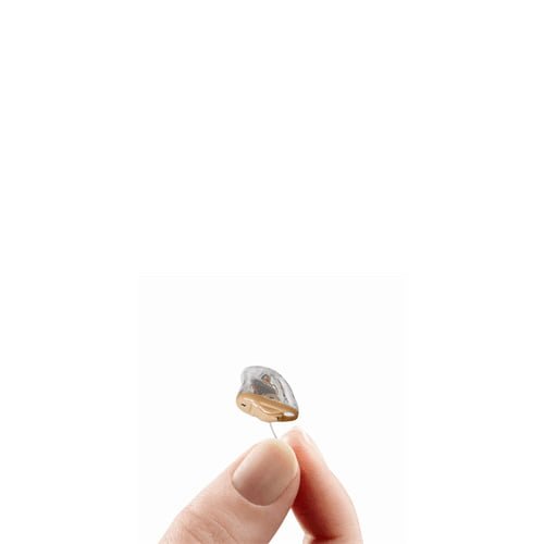 Fingers holding a completely in canal (CIC) hearing aid