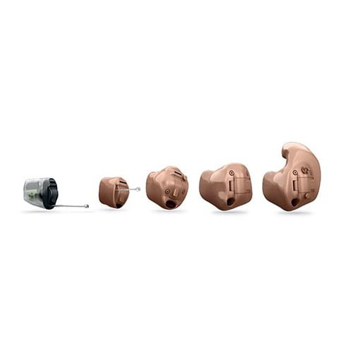 five different custom hearing aids lined up left to right